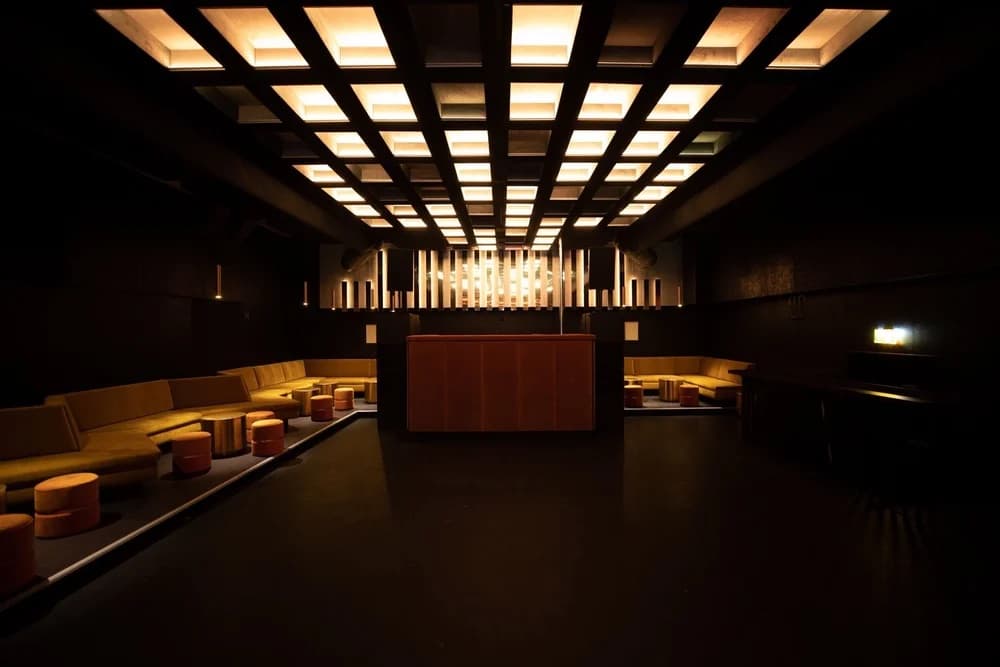 Club Cello's glowing coffered ceiling above empty gold banquette seating, a nightclub in Basel curated by Meetz