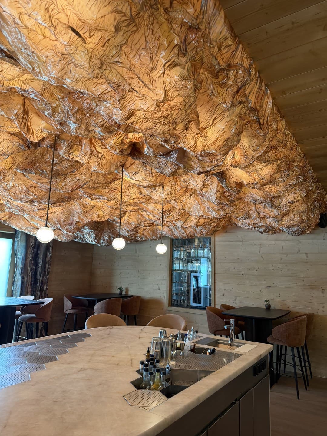 A crumpled copper ceiling above the Botanicum bar