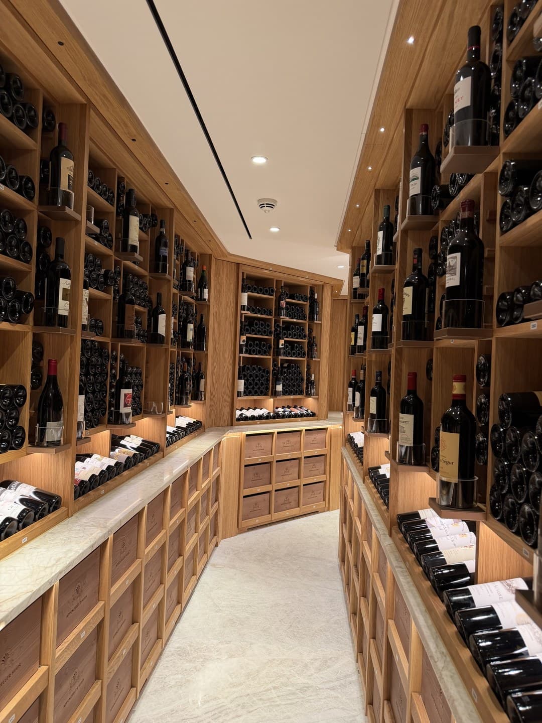 A wine cellar corridor lined with bottle racks