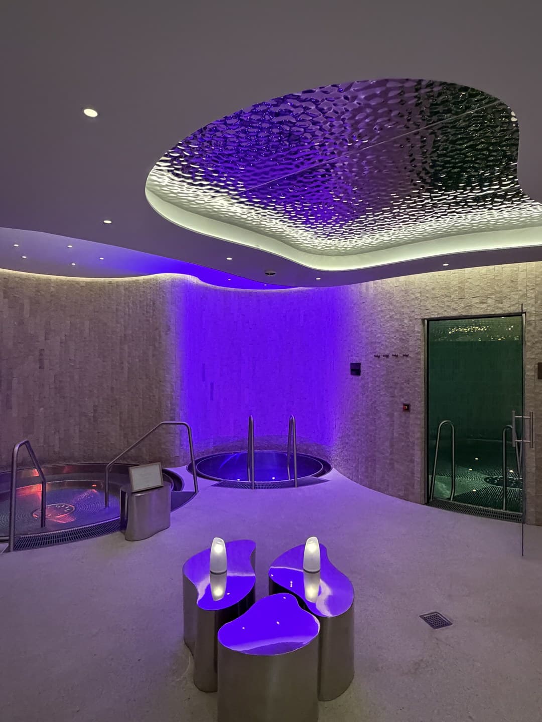 Plunge pools lit purple in the spa
