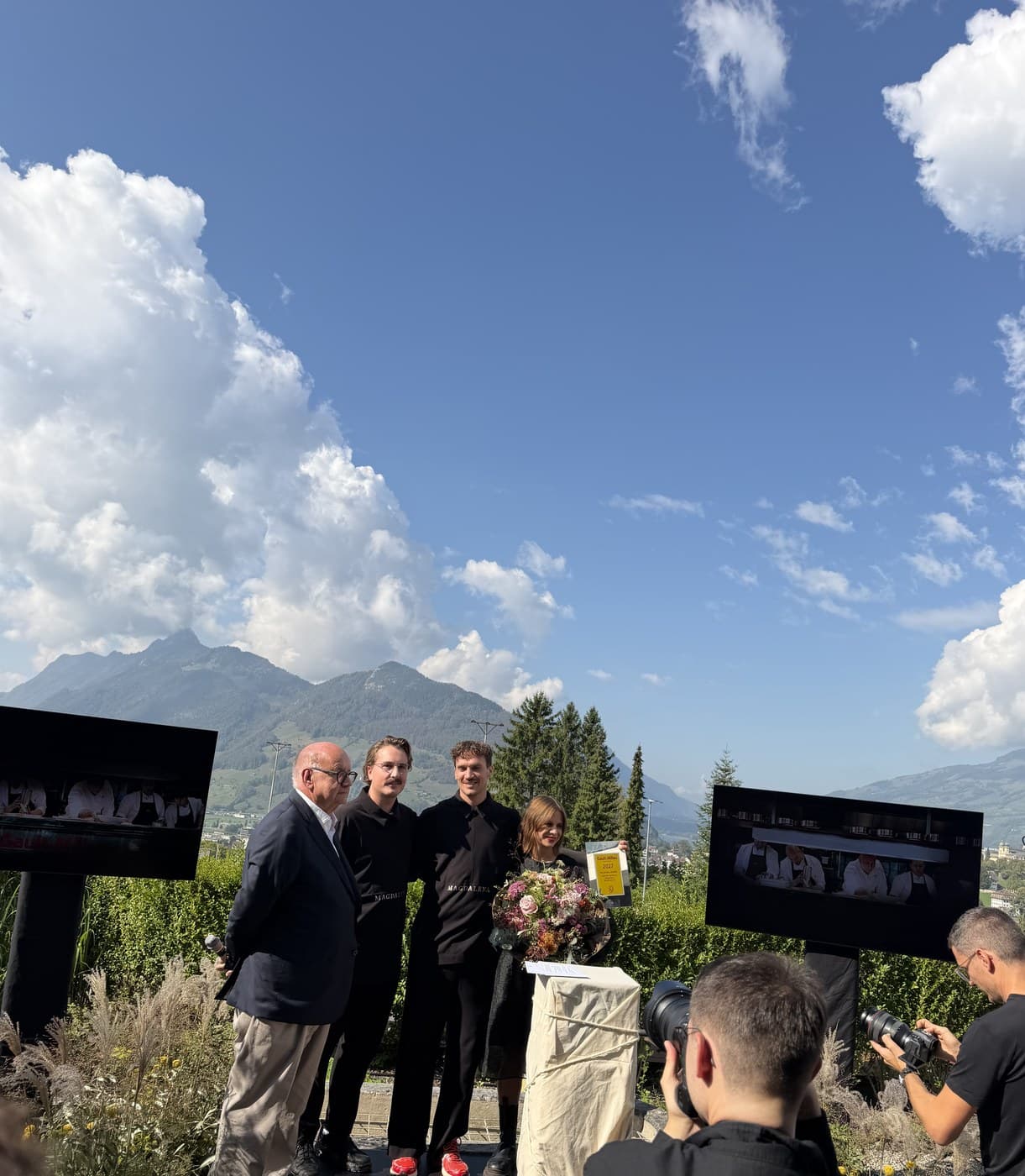 Dominik Hartmann, Marco Appert and Adriana Hartmann on stage with the Koch des Jahres 2027 certificate