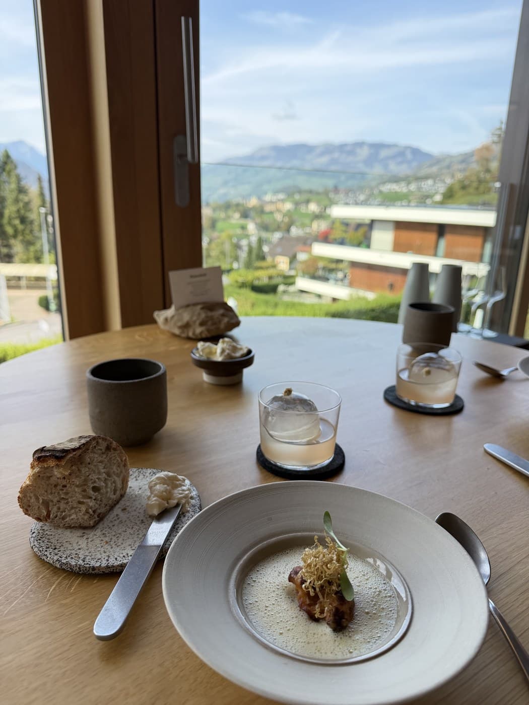 Bread, cultured butter and a cauliflower course, with the valley visible through the window